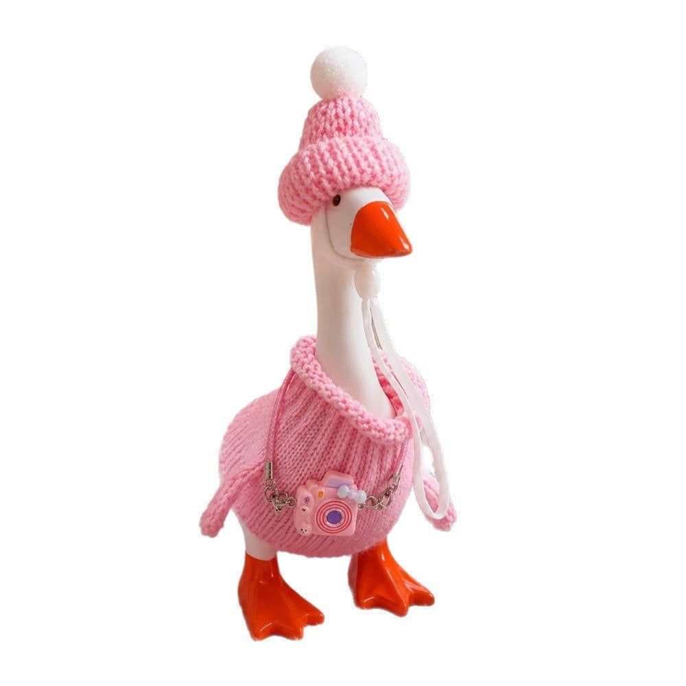 Pink knit sweater, beanie & camera – Little Honk desk goose outfit