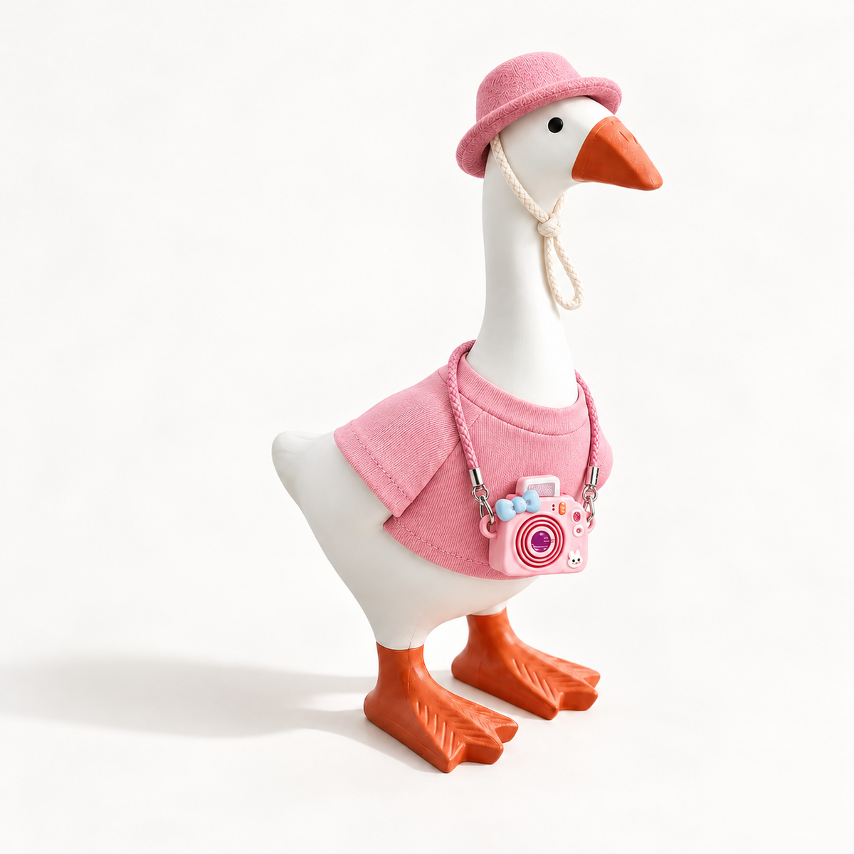 Pink Color Pop outfit with matching hat and camera charm on a 7-inch Little Honk Desk Goose