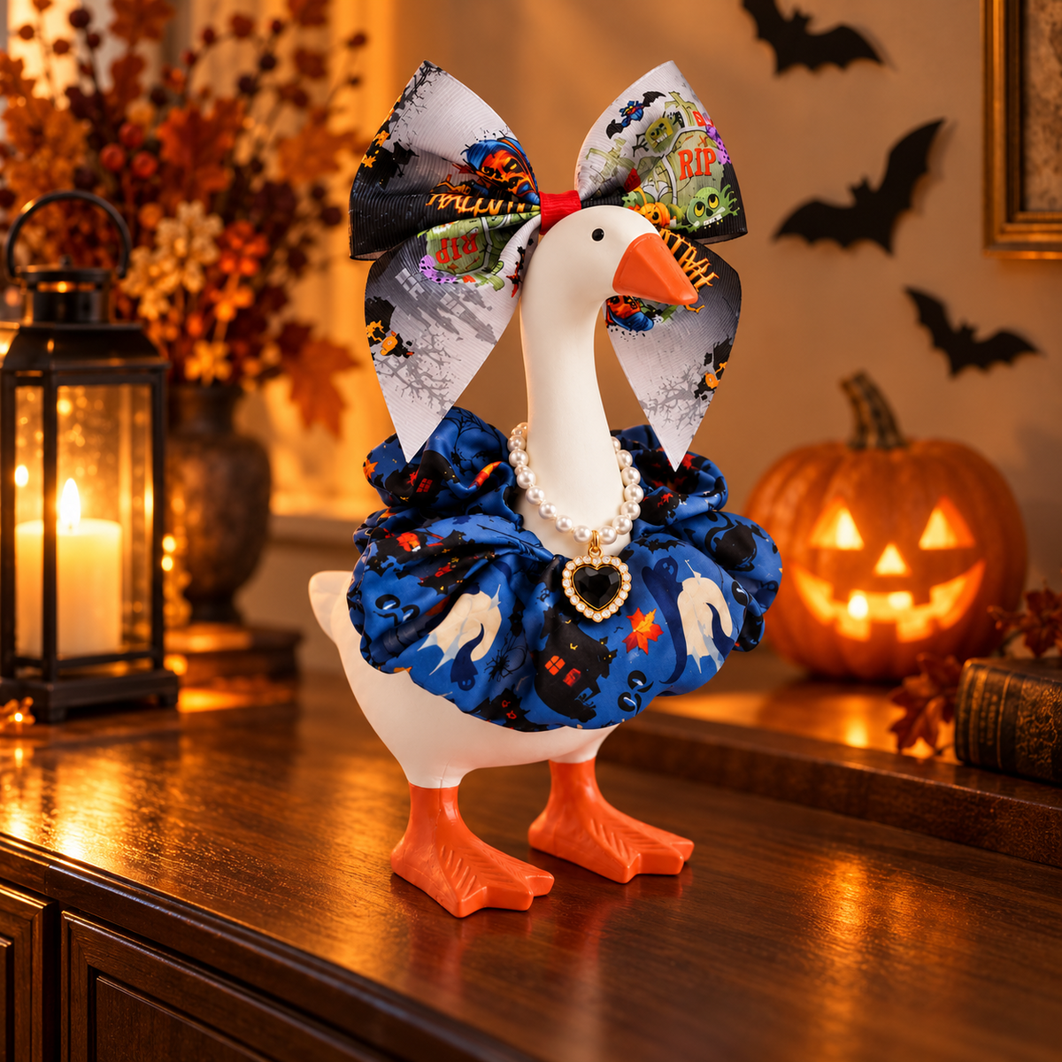 Little Honk Desk Goose wearing the midnight blue Halloween outfit beside a glowing pumpkin