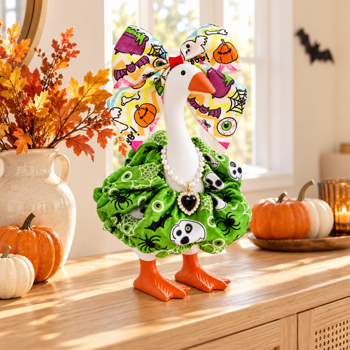 Little Honk Desk Goose wearing the monster green Halloween outfit in an autumn room