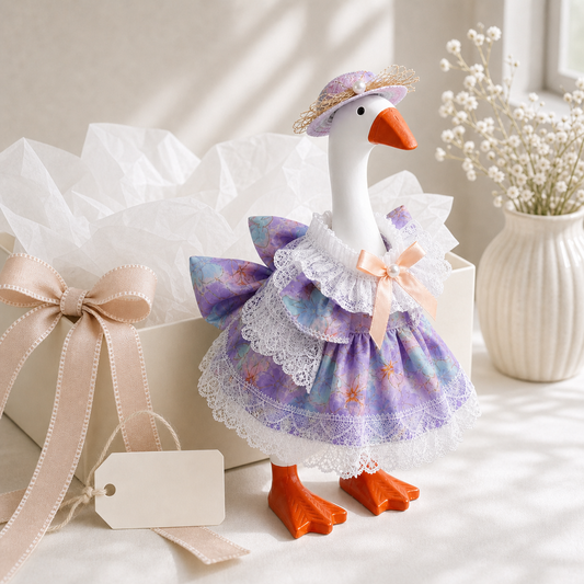 Little Honk wearing purple blue floral lace outfit with matching hat